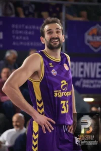 Basketball player in purple and yellow jersey #31 standing with hands on hips during a game of basketball.